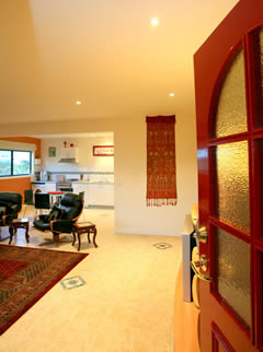 Elegantly furnished lounge and dining area opening onto large balcony.
